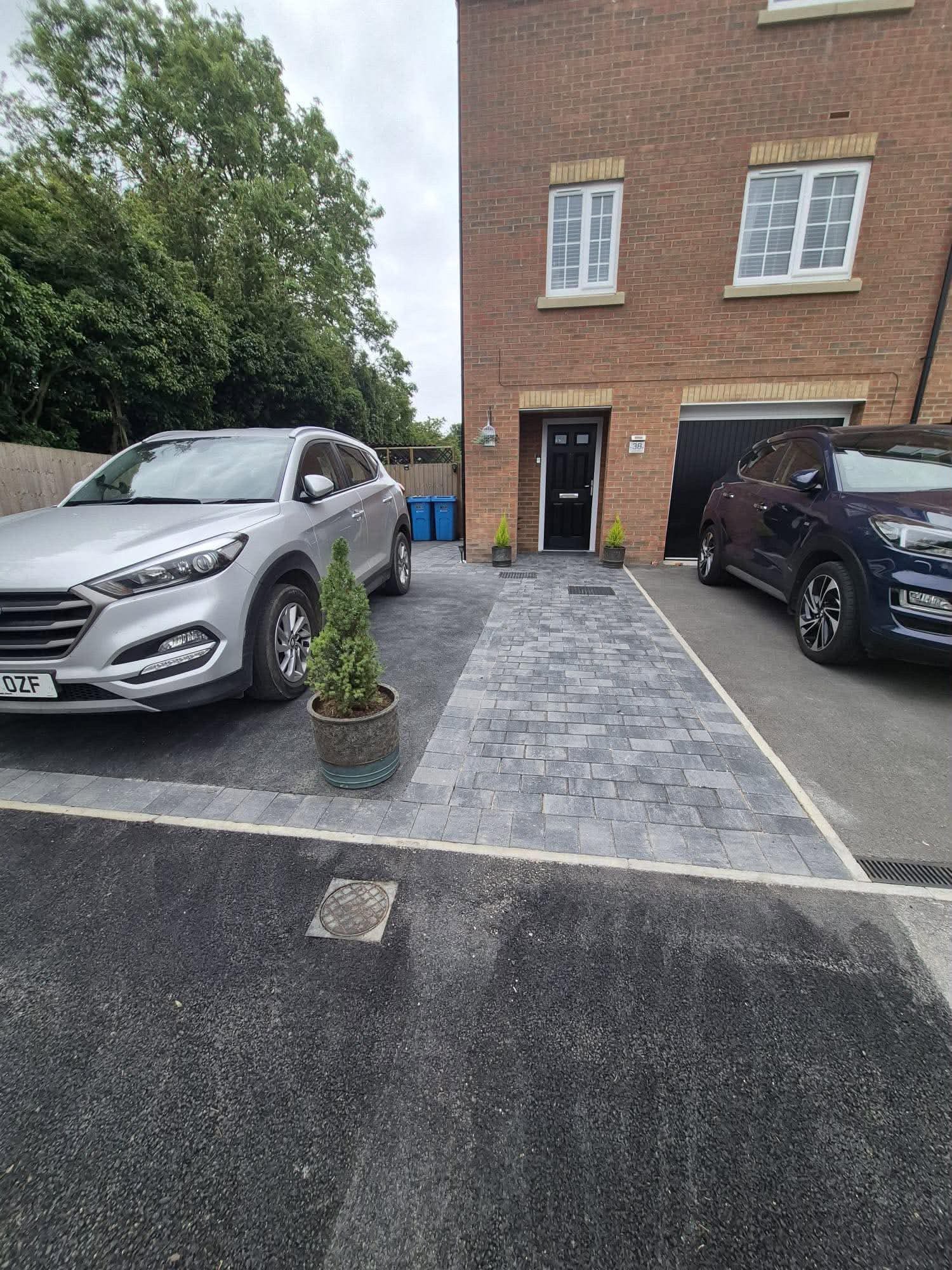 Block paving path, tarmac & raised sleeper beds — main view